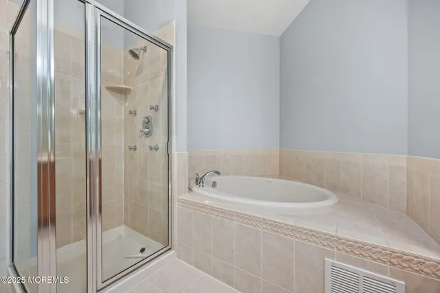 a bathroom with a bathtub and a shower
