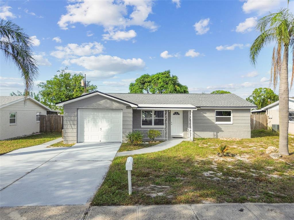 3635 Harvard Drive Holiday, FL 34691 - Photo 1 of 1 a front view of a house with a yard and potted plants