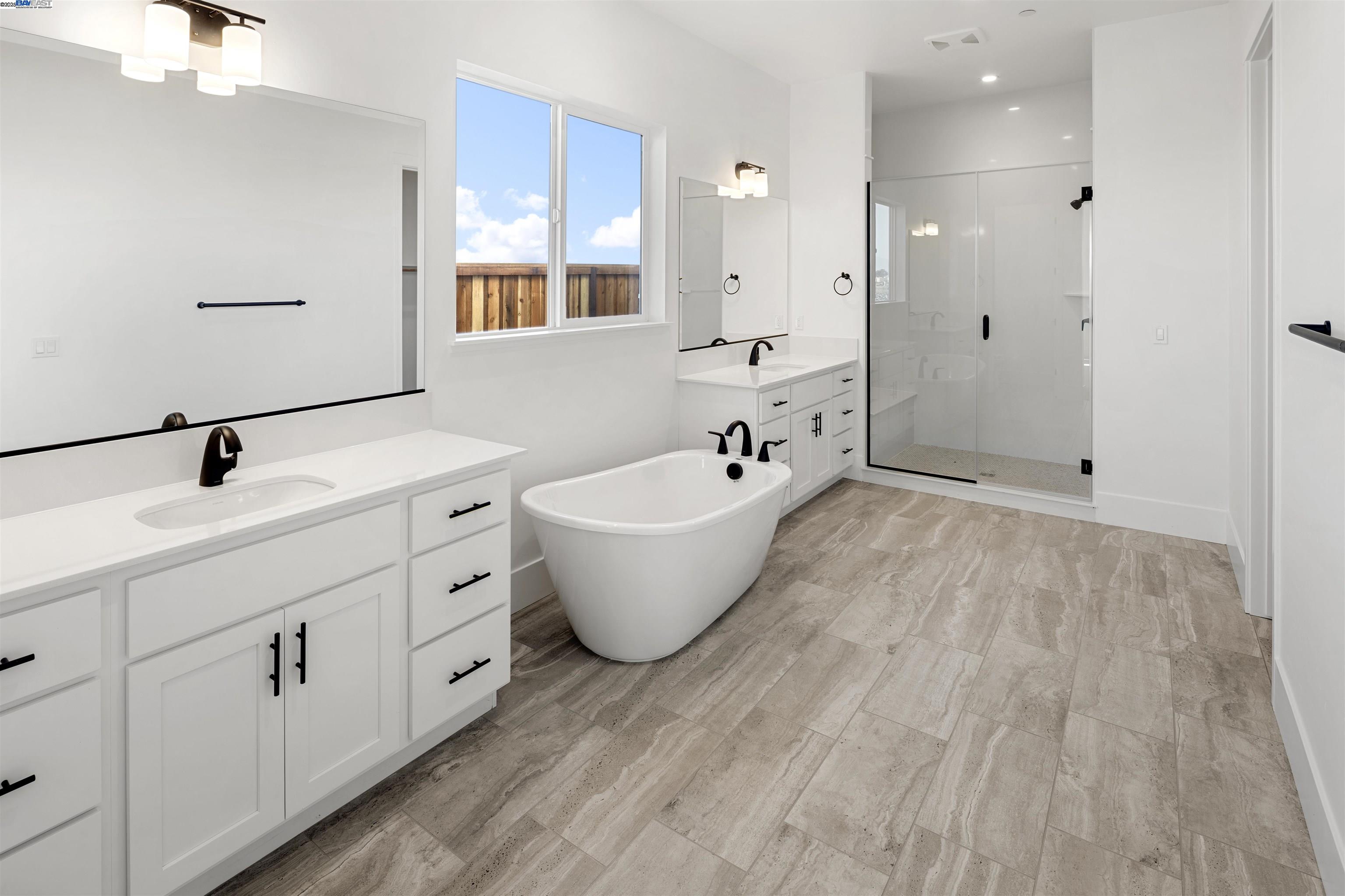 6012 Windsweep Road Bethel Island, CA 94511 - Photo 18 of 33 a bathroom with a double vanity sink a mirror and a bathtub