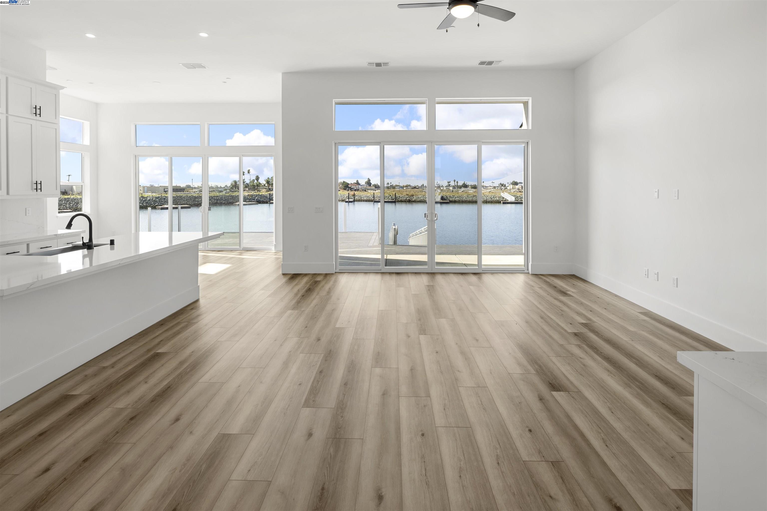6012 Windsweep Road Bethel Island, CA 94511 - Photo 4 of 33 a view of an empty room with wooden floor and a window