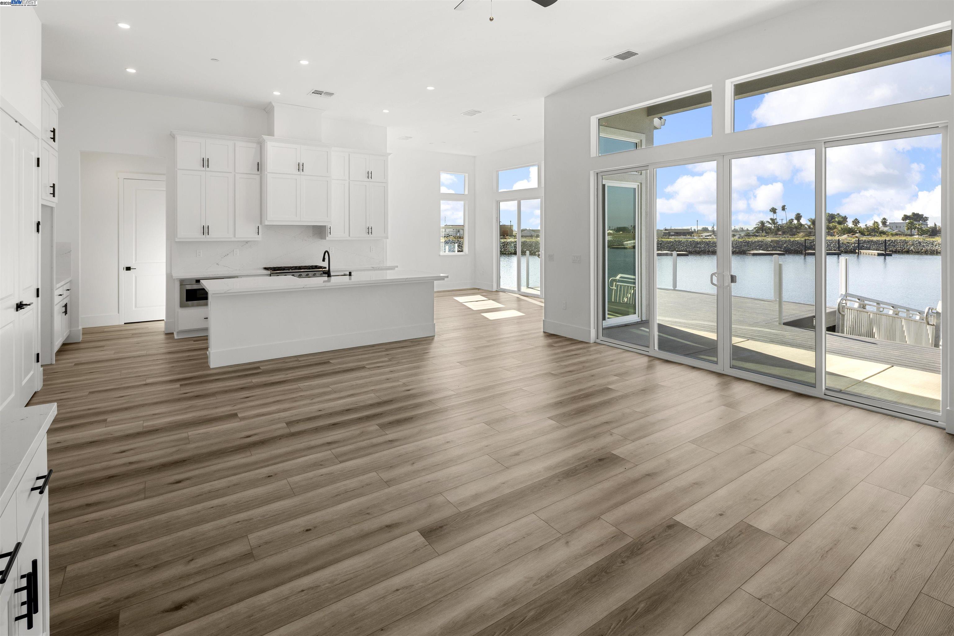 6012 Windsweep Road Bethel Island, CA 94511 - Photo 8 of 33 a large white kitchen with large windows