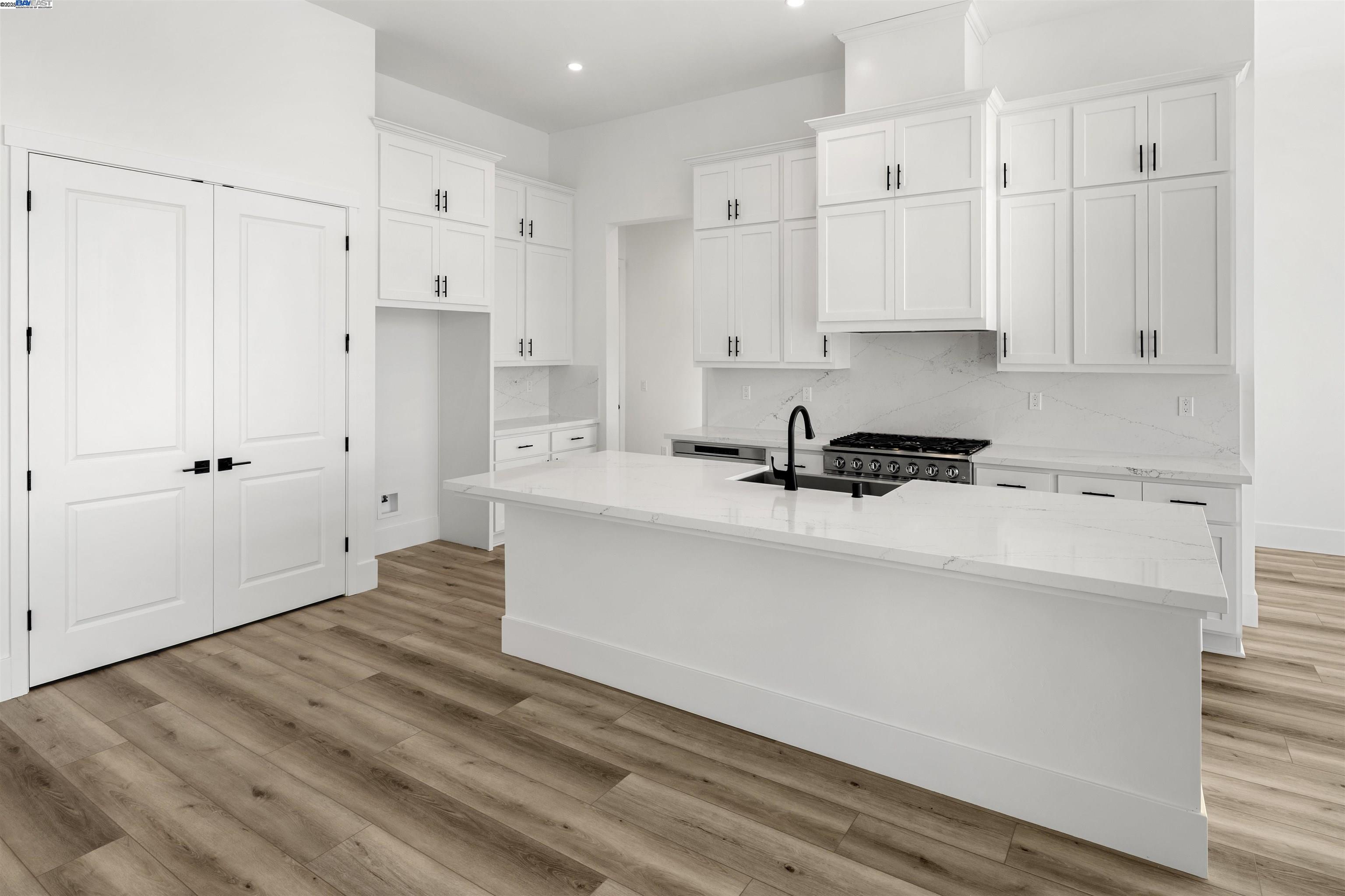 6012 Windsweep Road Bethel Island, CA 94511 - Photo 10 of 33 a kitchen with cabinets appliances and a wooden floor
