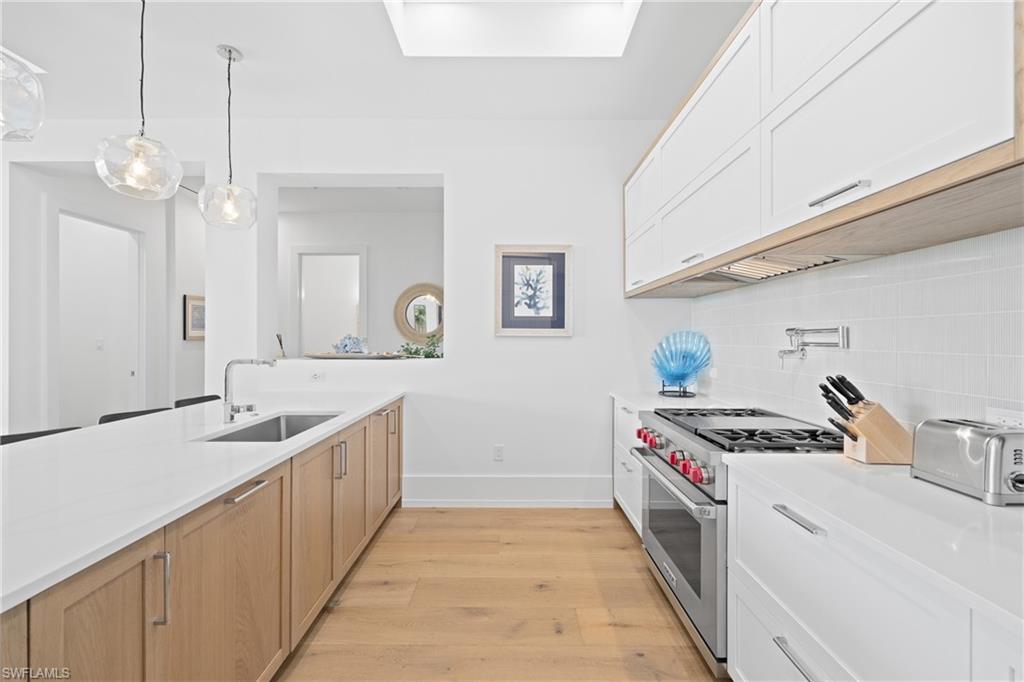 201 8th Street South, Unit 310 Naples, FL 34102 - Photo 11 of 40 a kitchen with stainless steel appliances granite countertop a sink and cabinets
