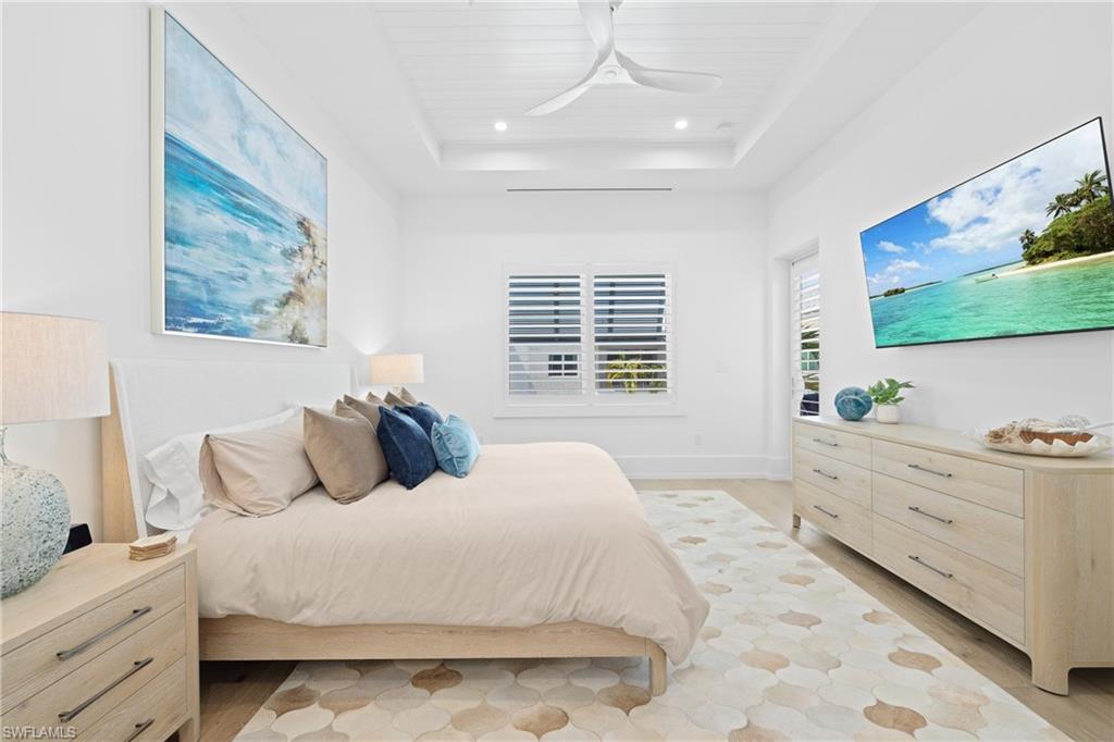 201 8th Street South, Unit 310 Naples, FL 34102 - Photo 15 of 40 a large white bed in a white room