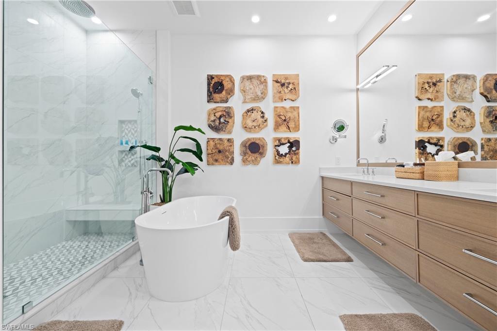 201 8th Street South, Unit 310 Naples, FL 34102 - Photo 16 of 40 a bathroom with a bathtub sink and toilet