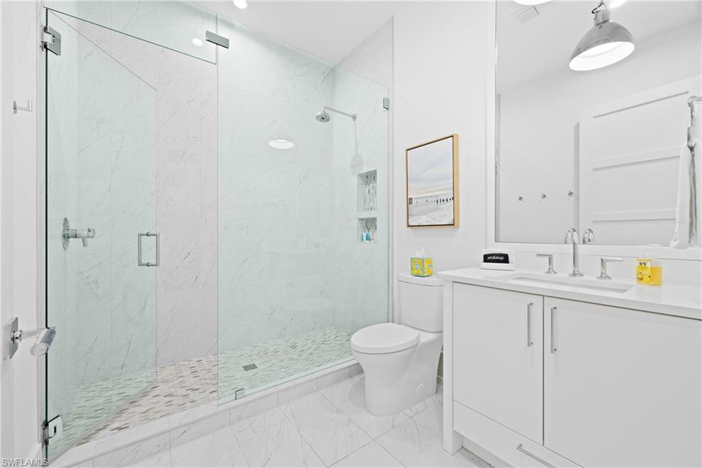 201 8th Street South, Unit 310 Naples, FL 34102 - Photo 20 of 40 a bathroom with a sink a toilet and shower