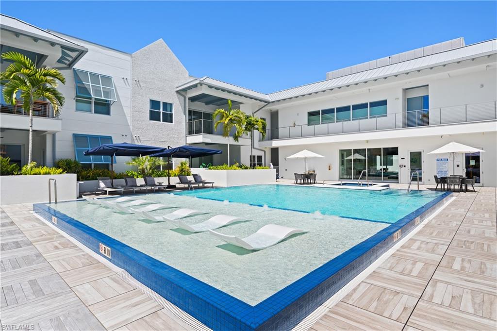 201 8th Street South, Unit 310 Naples, FL 34102 - Photo 2 of 40 a view of a white building with a yard
