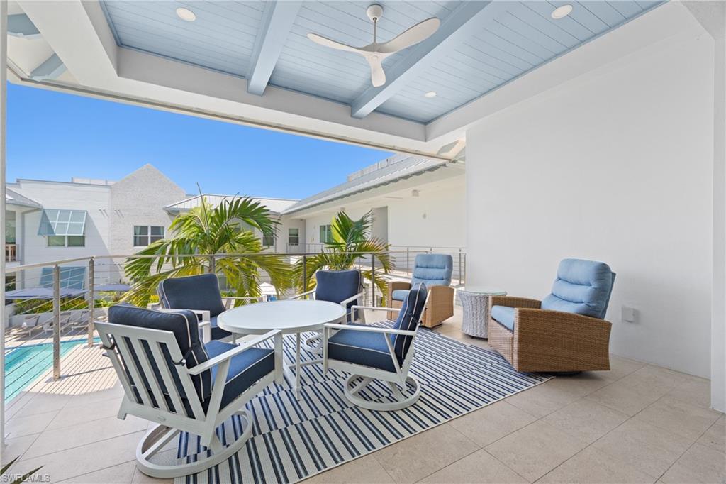 201 8th Street South, Unit 310 Naples, FL 34102 - Photo 24 of 40 a living room with furniture and a potted plant