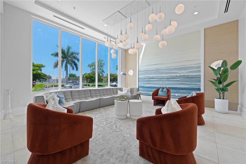 201 8th Street South, Unit 310 Naples, FL 34102 - Photo 34 of 40 a living room with fireplace furniture and a large window