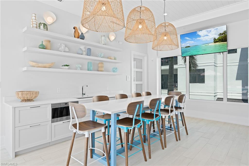 201 8th Street South, Unit 310 Naples, FL 34102 - Photo 35 of 40 a view of a dining room with furniture and chandelier