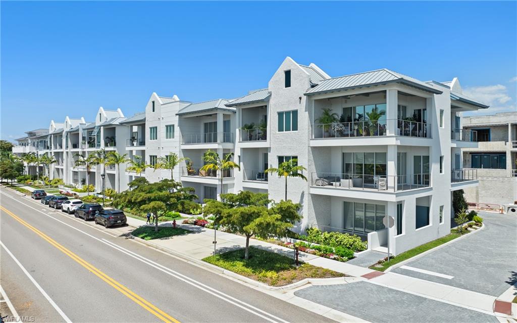 201 8th Street South, Unit 310 Naples, FL 34102 - Photo 39 of 40 a front view of a house with a garden