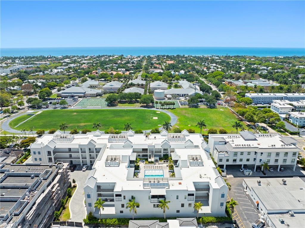201 8th Street South, Unit 310 Naples, FL 34102 - Photo 4 of 40 an aerial view of a building with an outdoor space and seating