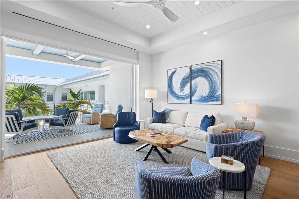 201 8th Street South, Unit 310 Naples, FL 34102 - Photo 5 of 40 a living room with furniture and a large window