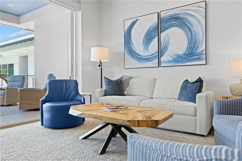 201 8th Street South, Unit 310 Naples, FL 34102 - Photo 6 of 40 a living room with furniture and a lamp