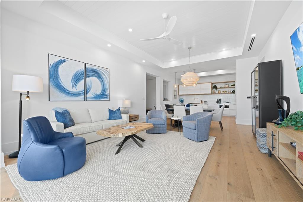 201 8th Street South, Unit 310 Naples, FL 34102 - Photo 7 of 40 a living room with furniture and a flat screen tv