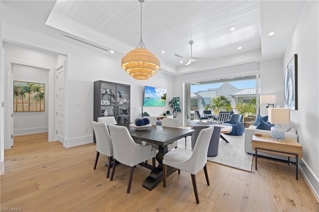 201 8th Street South, Unit 310 Naples, FL 34102 - Photo 8 of 40 a view of a dining room with furniture window and wooden floor