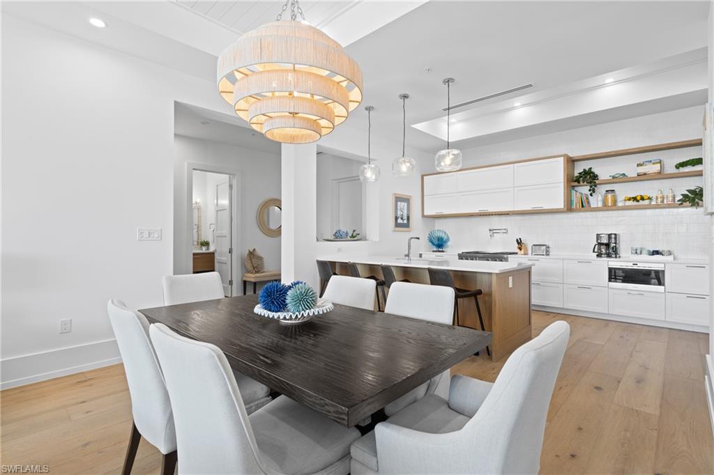 201 8th Street South, Unit 310 Naples, FL 34102 - Photo 9 of 40 a view of a dining room with furniture and wooden floor