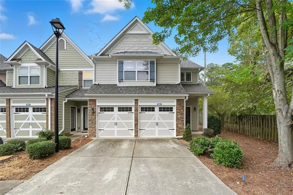 a front view of a house with a garden