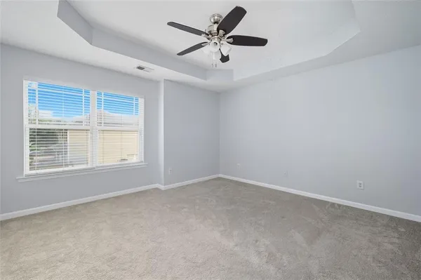 a view of an empty room and a ceiling fan