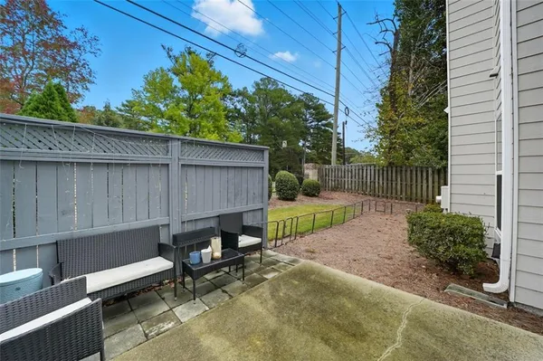 a backyard of a house with table and chairs
