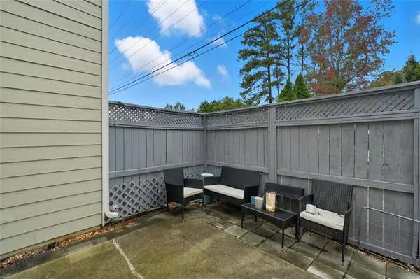 a view of a house with backyard and sitting area