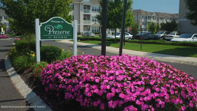 a view of a street sign of the house and tree