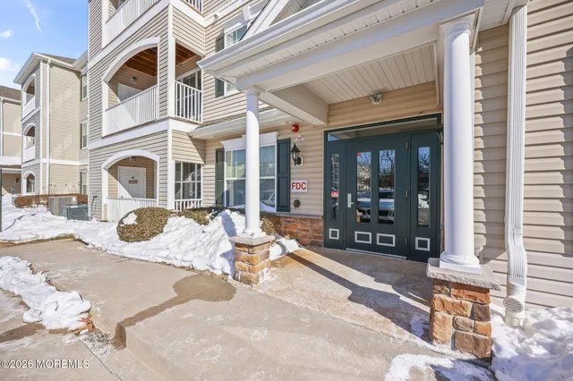 a view of empty room with wooden floor and fireplace