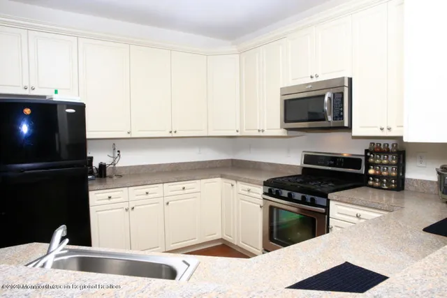 a kitchen with a sink stove and microwave