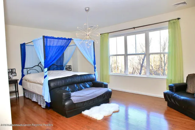 a bedroom with a bed couch and window