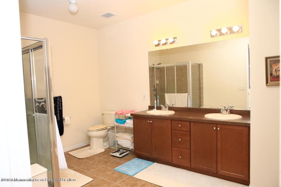 416 Sloan Court Matawan, NJ 07747 - Photo 7 of 9 a bathroom with a double vanity sink mirror and toilet