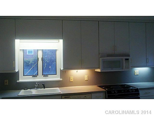 2919 Sharon Road Charlotte, NC 28211 - Photo 5 of 12 a kitchen with a cabinets and window