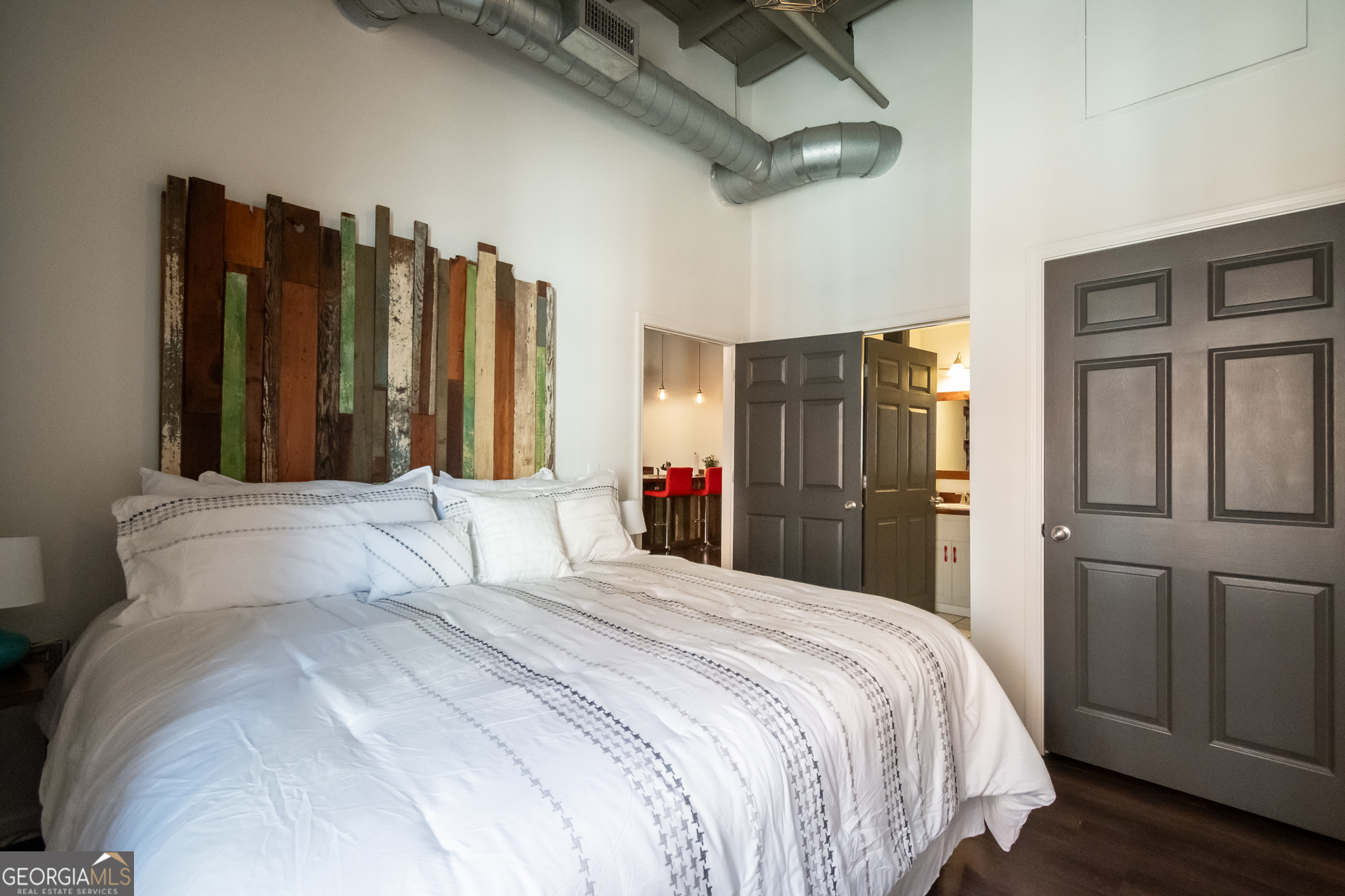 269 North Hull Street, Unit 202 Athens, GA 30601 - Photo 21 of 25 a bedroom with a bed and a large mirror