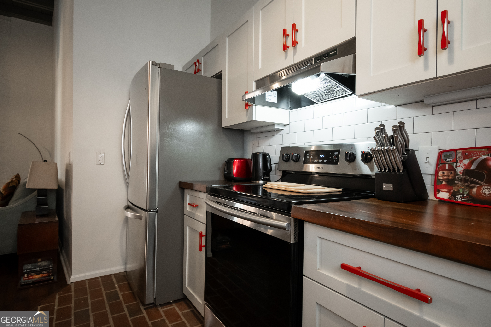 269 North Hull Street, Unit 202 Athens, GA 30601 - Photo 6 of 25 a kitchen with stainless steel appliances granite countertop a refrigerator and a stove