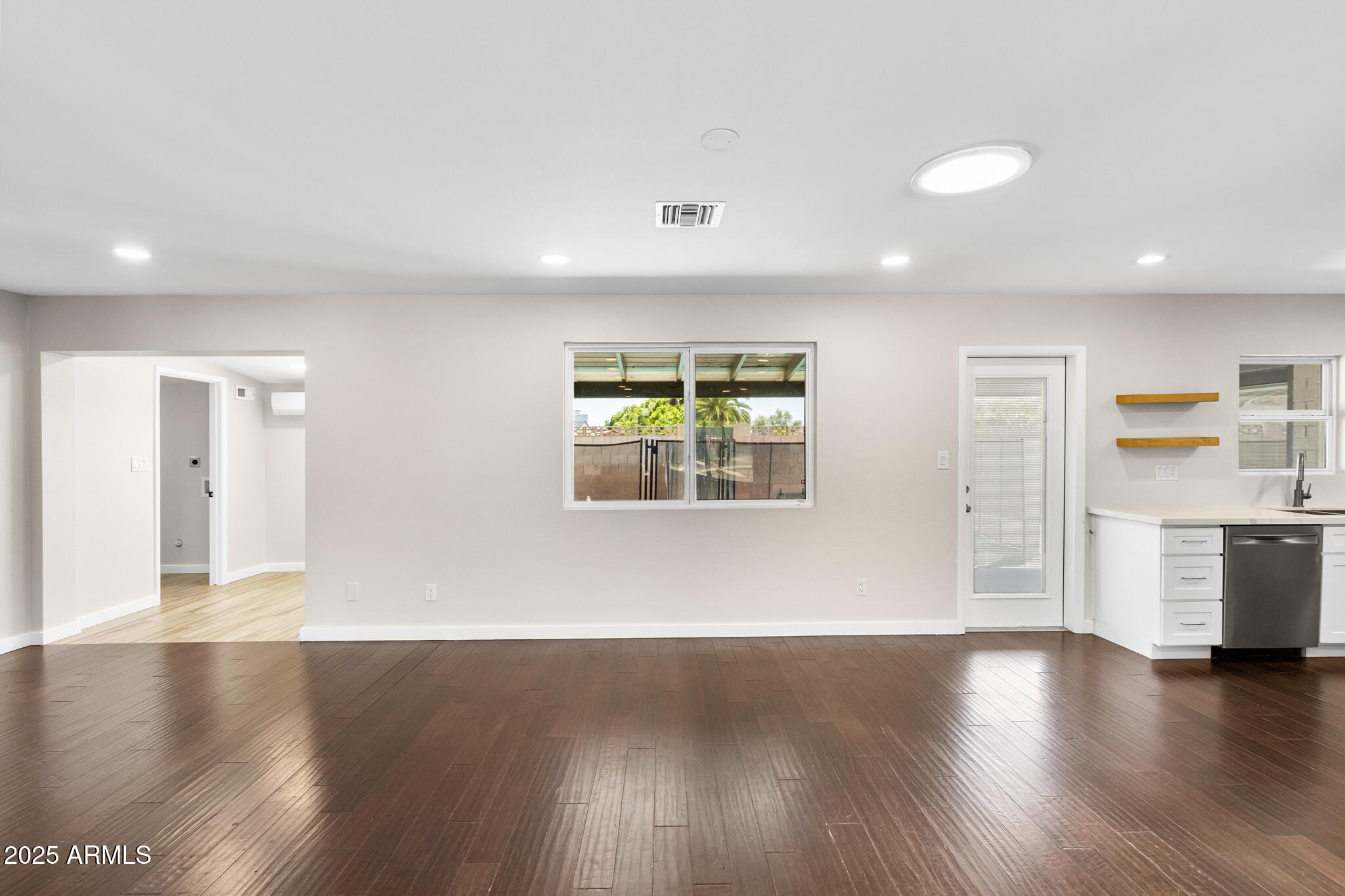 1911 East Lawrence Road Phoenix, AZ 85016 - Photo 13 of 49 a view of an empty room with window and wooden floor