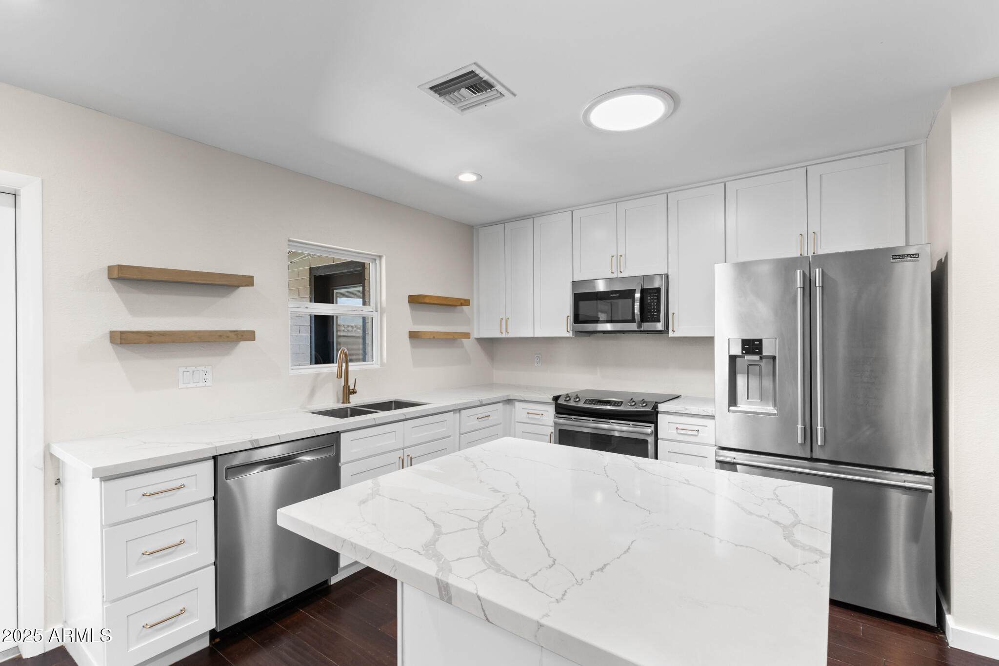 1911 East Lawrence Road Phoenix, AZ 85016 - Photo 15 of 49 a kitchen with stainless steel appliances a refrigerator stove microwave and cabinets