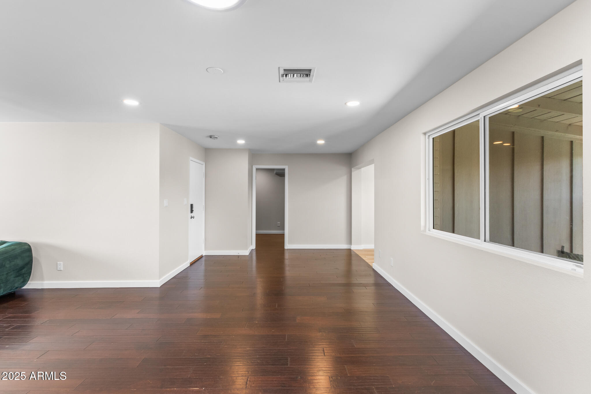 1911 East Lawrence Road Phoenix, AZ 85016 - Photo 19 of 49 a view of an empty room with wooden floor