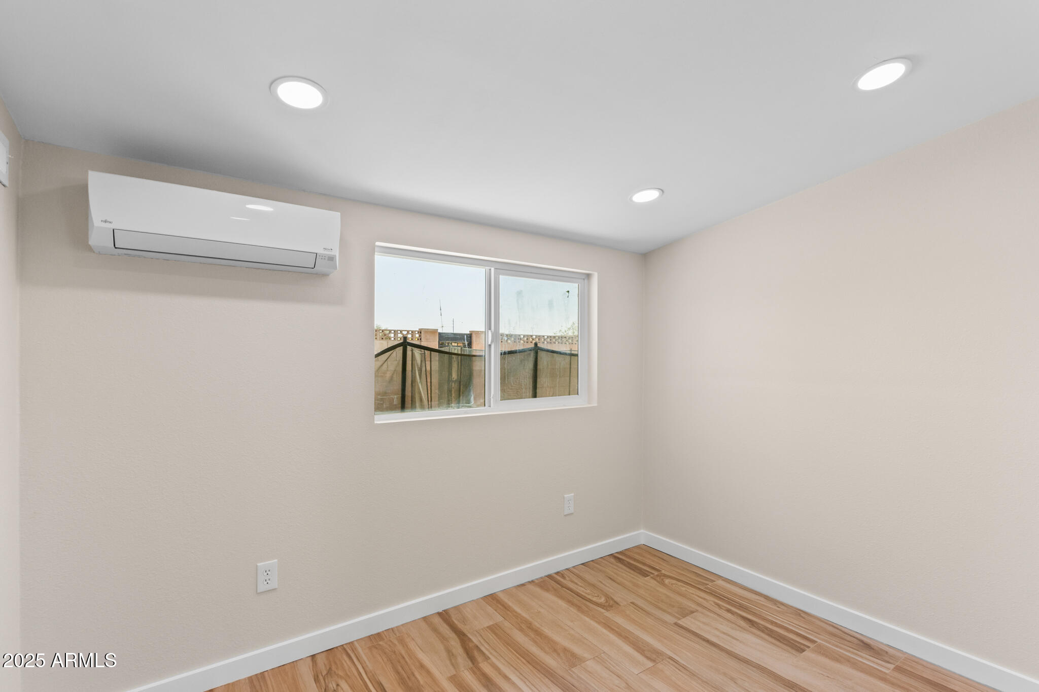 1911 East Lawrence Road Phoenix, AZ 85016 - Photo 26 of 49 a view of an empty room with wooden floor and a window