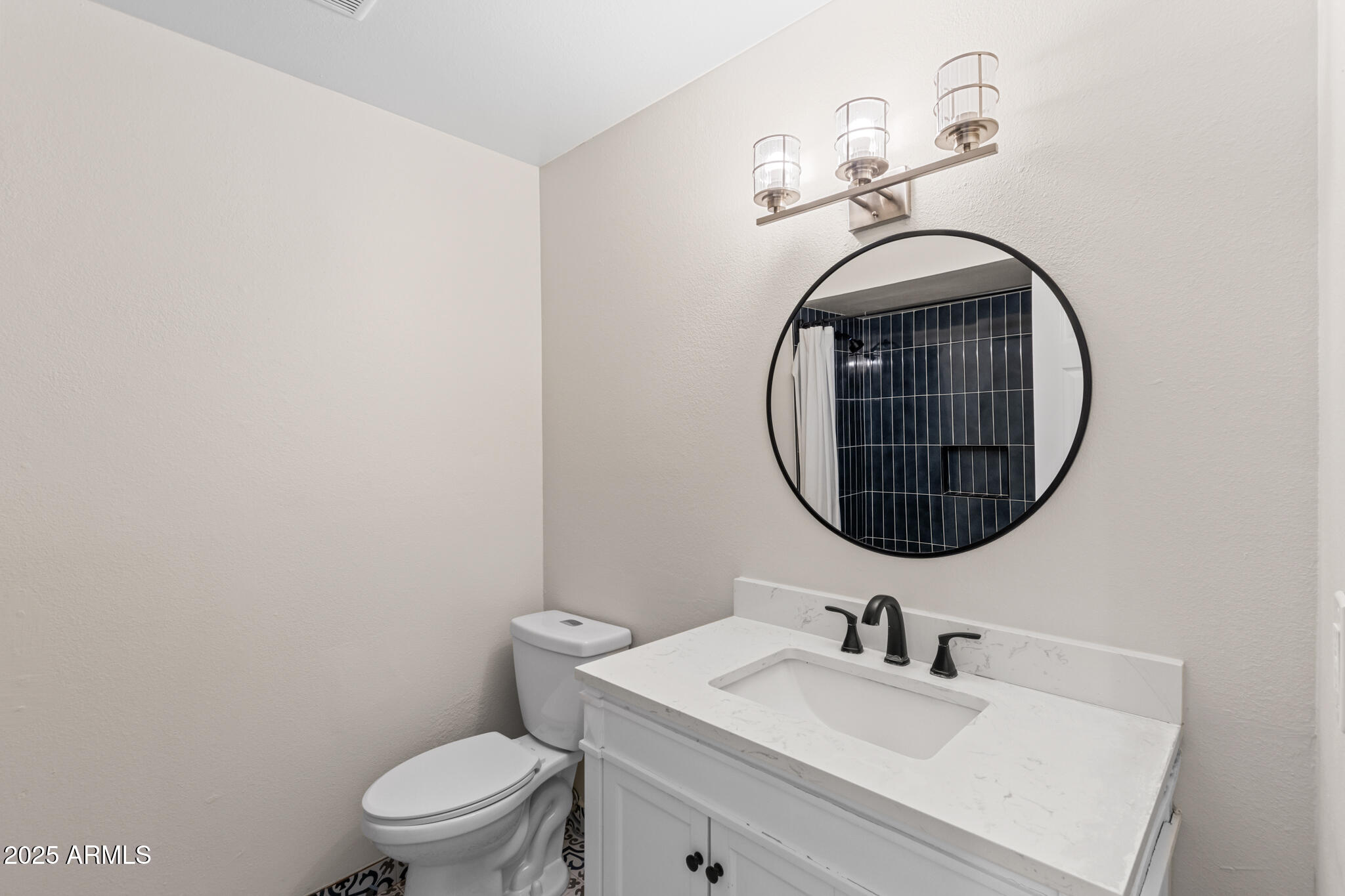 1911 East Lawrence Road Phoenix, AZ 85016 - Photo 28 of 49 a bathroom with a toilet a sink and a mirror
