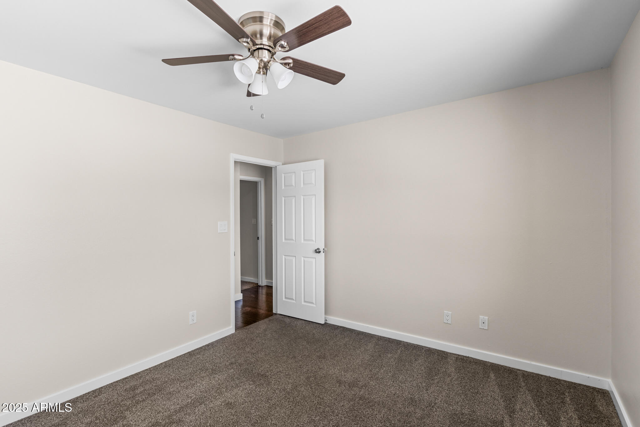 1911 East Lawrence Road Phoenix, AZ 85016 - Photo 31 of 49 an empty room with a ceiling fan and a window