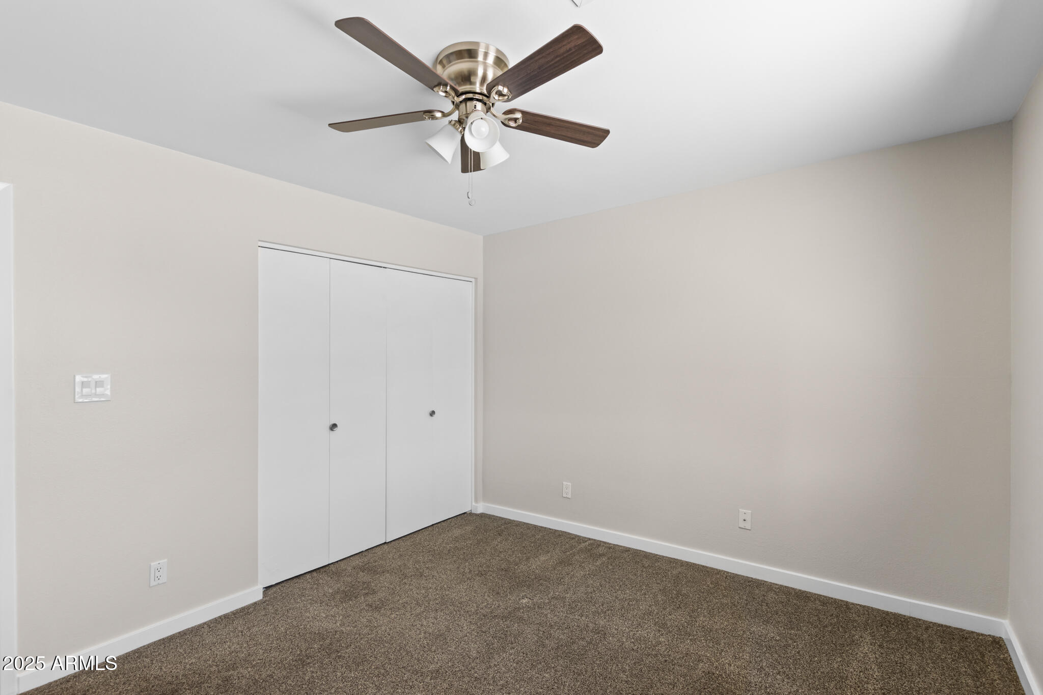 1911 East Lawrence Road Phoenix, AZ 85016 - Photo 33 of 49 an empty room with a chandelier fan