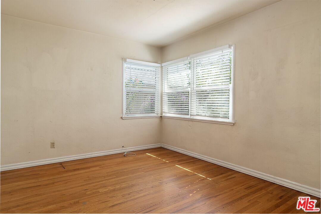 722 South McClelland Street Santa Maria, CA 93454 - Photo 17 of 27 an empty room with wooden floor and windows