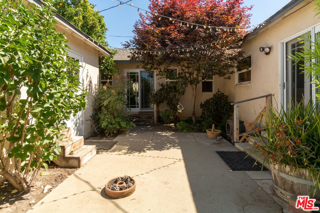 722 South McClelland Street Santa Maria, CA 93454 - Photo 21 of 27 a view of a white house with a yard and potted plants