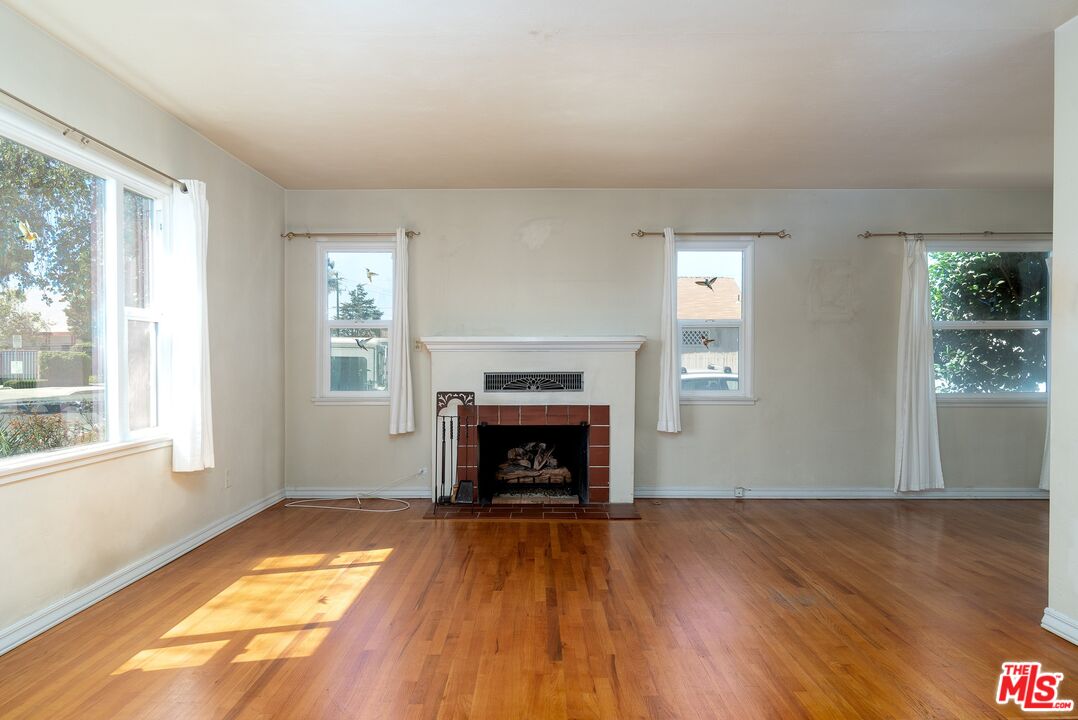 722 South McClelland Street Santa Maria, CA 93454 - Photo 6 of 27 wooden floor fireplace and windows in an empty room