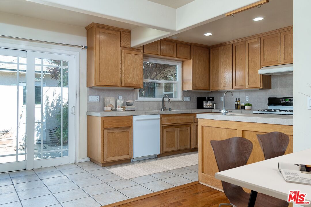 722 South McClelland Street Santa Maria, CA 93454 - Photo 8 of 27 a kitchen with granite countertop a stove a sink and a refrigerator