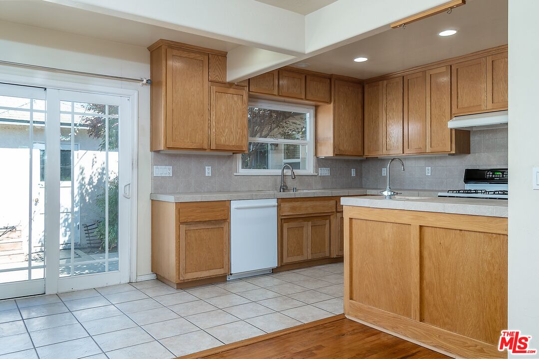 722 South McClelland Street Santa Maria, CA 93454 - Photo 9 of 27 a kitchen with stainless steel appliances granite countertop a stove a sink and a refrigerator