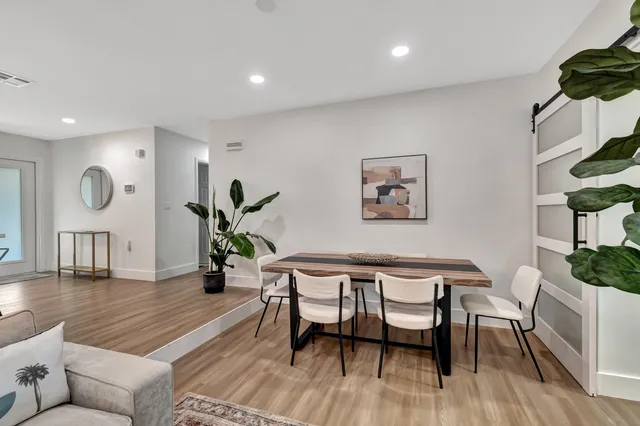 a dining room with furniture and wooden floor