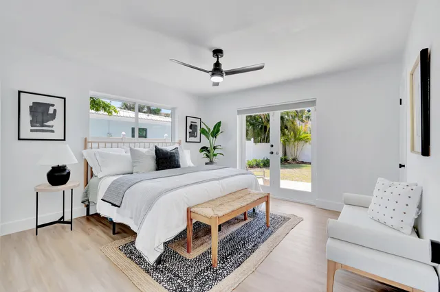 a spacious bedroom with a bed a couch and a window