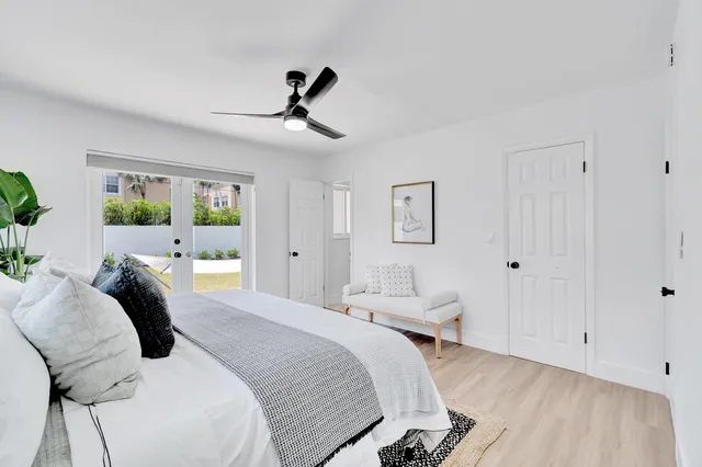 a bed room with a bed and a chandelier