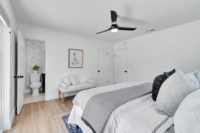 a bedroom with a bed and a chandelier