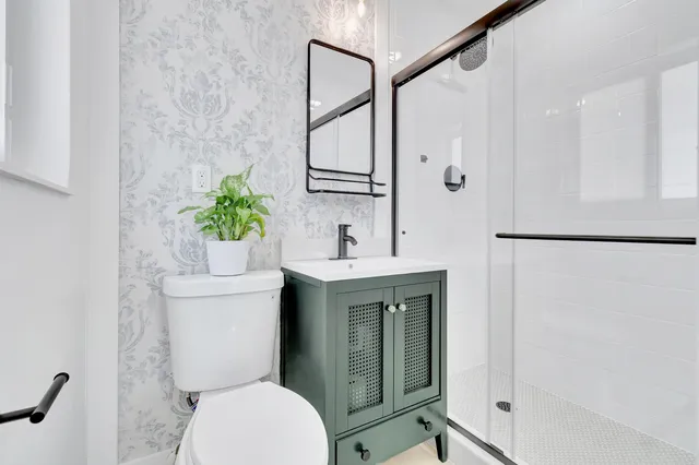a bathroom with a toilet sink and shower